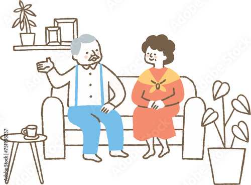 自宅のリビングで会話をしている高齢夫婦_色