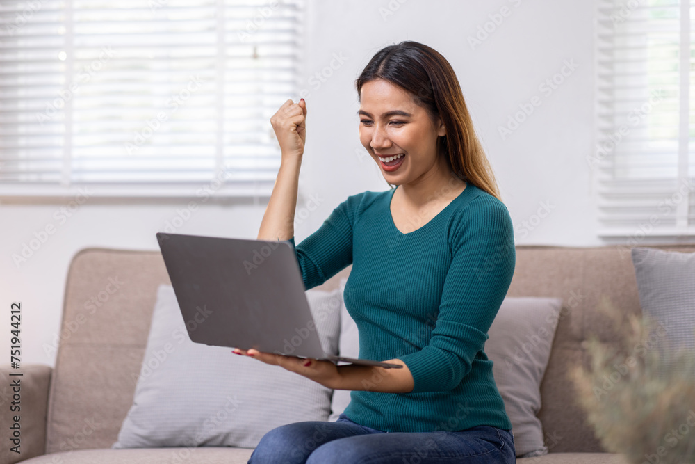 Happy young asian woman relax on comfortable couch at home texting messaging on laptop smartphone, smiling girl use cellphone chatting, browse wireless internet on gadget, work online from home Happy young asian woman relax on comfortable couch at home texting messaging on laptop smartphone, smiling girl use cellphone chatting, browse wireless internet on gadget, work online from home