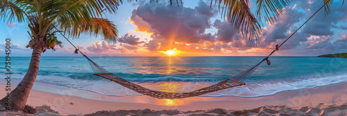 A hammock is hanging from a palm tree on a sandy beach, swaying gently in the breeze. The scene captures a relaxing moment by the ocean, inviting viewers to imagine themselves lounging in the shade