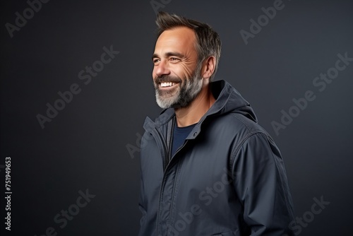 Portrait of a smiling middle-aged man in a jacket.