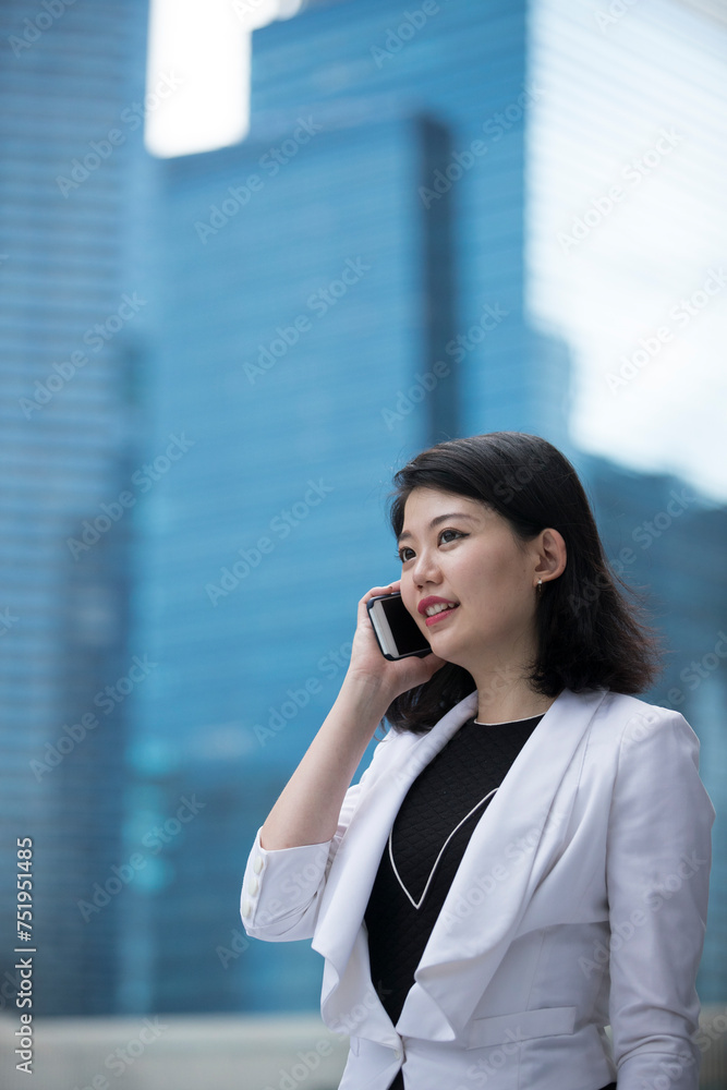 Asian businesswoman talking on smart phone. Asian businesswoman talking on smart phone.