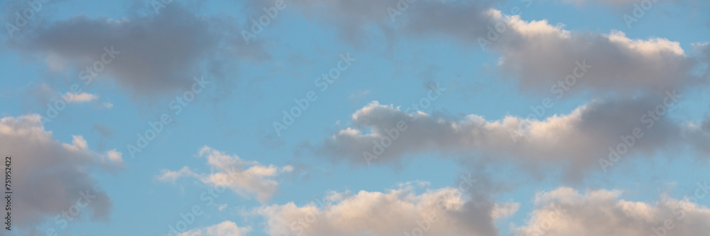 Fototapeta premium Beautiful sunset sky background with clouds. Scenic cloudscape. Wide panoramic background for design.