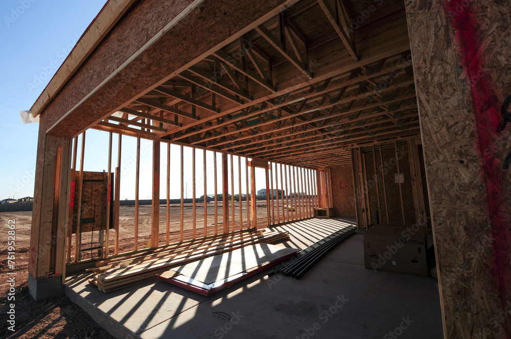 A wide-angle perspective captures the garage area of a wooden home under construction in southeastern Maricopa County, Arizona