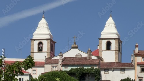 The two white towers of the Church of Santa Maria da Devesa in the middle at the top of the village photo