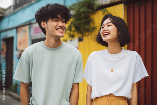 two young happy asian people walking in a street, couple talking and laughing, wearing casual white and light green tshirts, necklace, colorful background, cheerful, upbeat, relationship, friendship