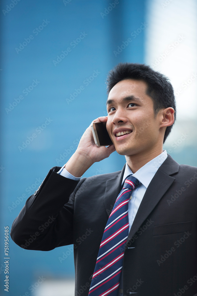 Chinese business man talking on a mobile phone Chinese business man talking on a mobile phone