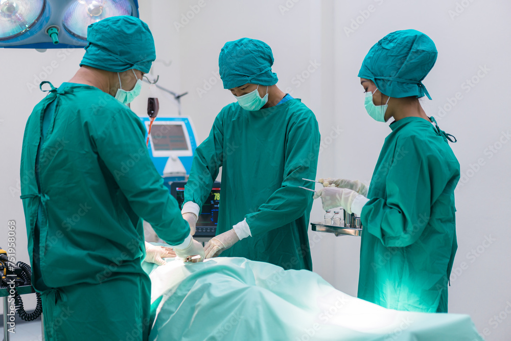Medical team doing critical operation. Group of surgeons in operating room with surgery equipment at hospital. Medical team doing critical operation. Group of surgeons in operating room with surgery equipment at hospital.