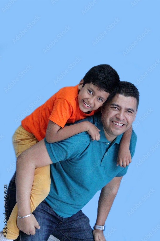 Fototapeta premium Divorced single dad and his 9-year-old dark-skinned Latino son play and spend quality time and fun celebrating Father's Day