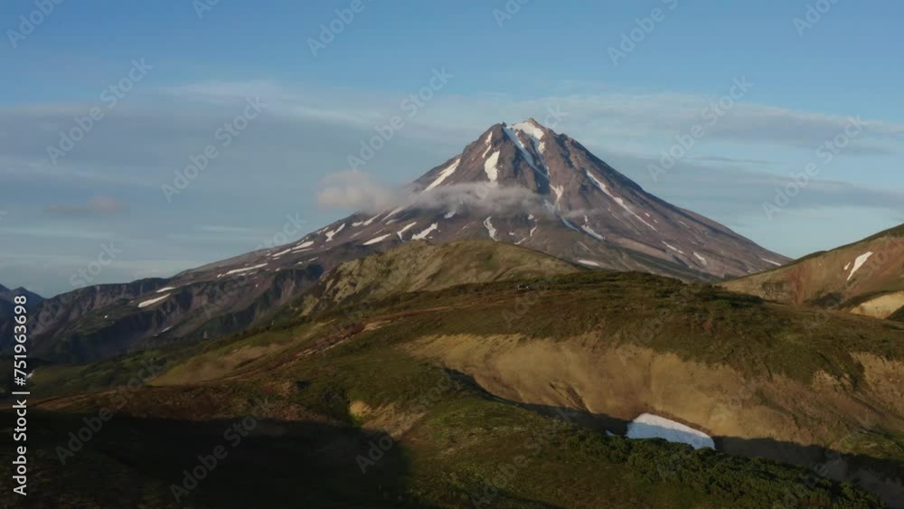 Drone shot over truck driving on a gravel road onto a mountain. Kamchatka Russia, Unesco World Heritage. Drone shot over truck driving on a gravel road onto a mountain. Kamchatka Russia, Unesco World Heritage.