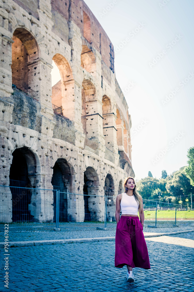 young woman posing next to the Roman colosseum