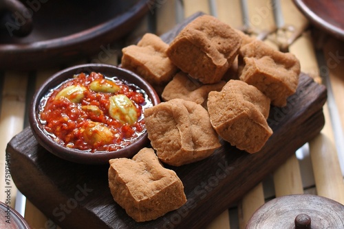Savory and delicious fried tofu served with garlic chili sauce and petai photo