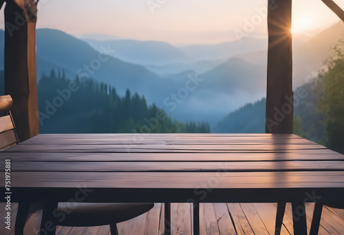 Wooden terrace with scenic foggy mountain view at sunrise.
