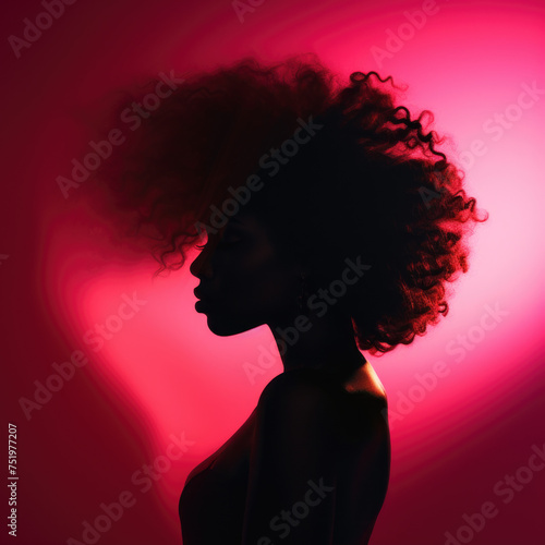 Silhouette of a woman with an afro in pink backlight