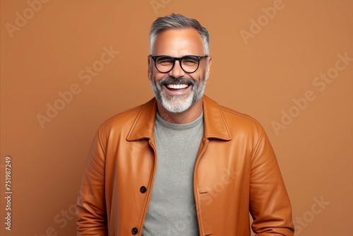 Portrait of a happy senior man in leather jacket and glasses. © Iigo