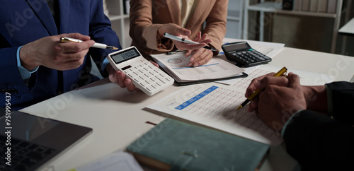 Business teamwork discussing brainstorming and calculating with a calculator on evaluation data in the conference room Focus on business growth and point out financial accounting charts.