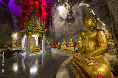 
The golden Buddha statues are placed inside a cave at Tham Khao Yoi Temple in Phetchaburi Province. It's a beautiful tourist attraction in Thailand.