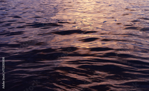 Sunlight reflecting on ocean waves on sunset time background © Alex
