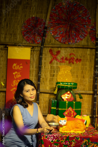 Woman wearing trendy clothes, well-proportioned figure of 35 years old, beautiful colors in Sai Gon's Tet season