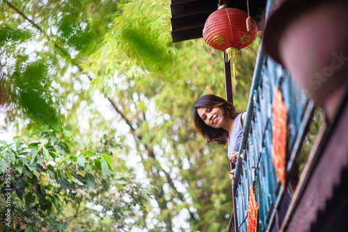 Woman wearing trendy clothes, well-proportioned figure of 35 years old, beautiful colors in Sai Gon's Tet season