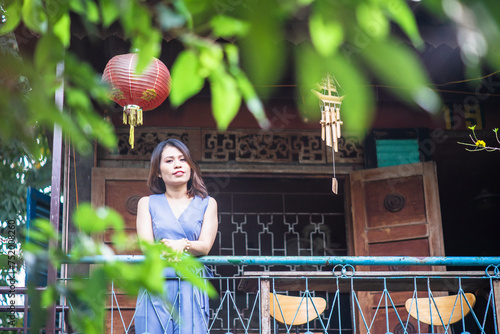 Woman wearing trendy clothes, well-proportioned figure of 35 years old, beautiful colors in Sai Gon's Tet season