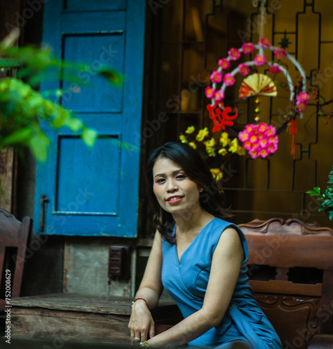 Woman wearing trendy clothes, well-proportioned figure of 35 years old, beautiful colors in Sai Gon's Tet season