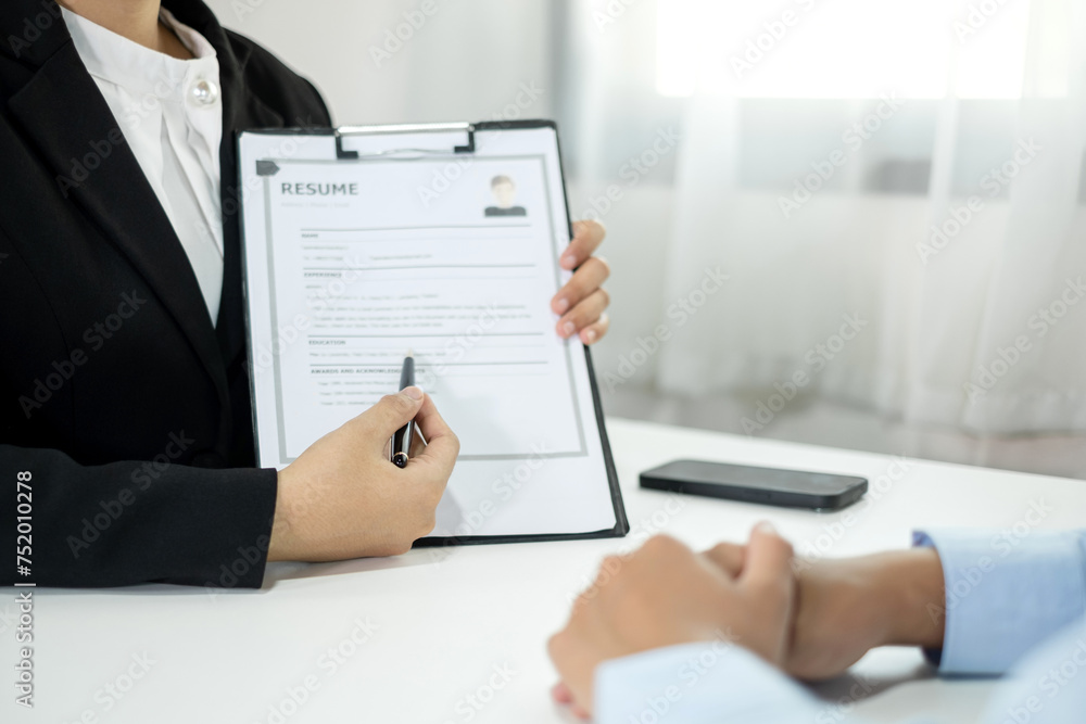 Business people hold a resume and talk to job applicants for job interviews about careers and Their personal history in the company. Recruitment concepts Business people hold a resume and talk to job applicants for job interviews about careers and Their personal history in the company. Recruitment concepts