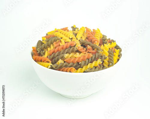 An image flat lay isolated pasta spiral in the bowl white is a food  raw dry for ingredient cook food a homemade white background.