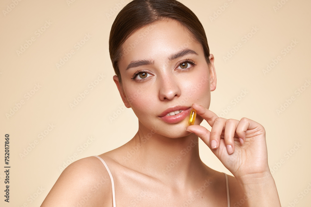 Vitamins. Close Up Of Happy Beautiful Girl With Pill With Cod Liver Oil Omega-3. Nutrition. Vitamin D, E, A Fish Oil Capsules. Healthy Lifestyle. Sport, Diet Concept Vitamins. Close Up Of Happy Beautiful Girl With Pill With Cod Liver Oil Omega-3. Nutrition. Vitamin D, E, A Fish Oil Capsules. Healthy Lifestyle. Sport, Diet Concept
