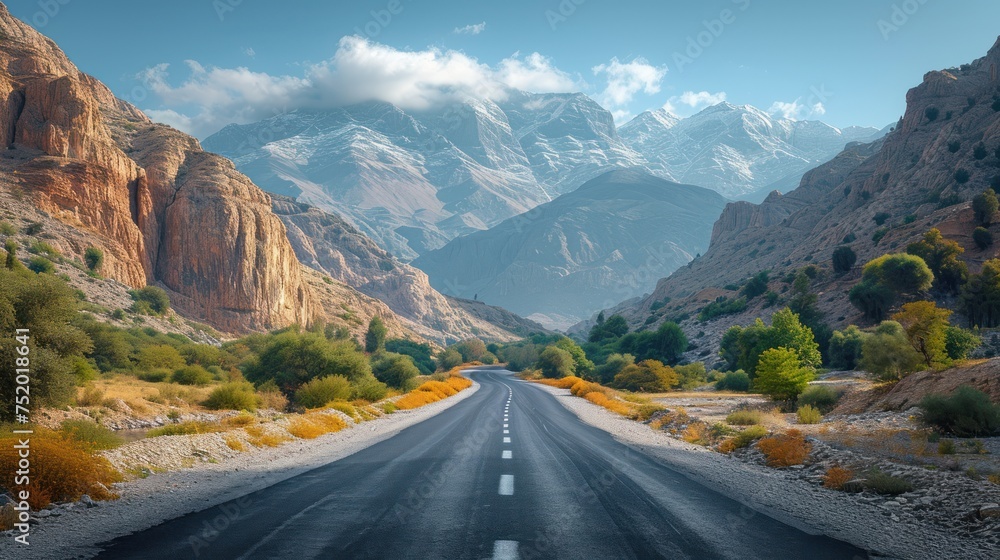 Desert view of a high mountain winding road with steep mountain walls in the background Desert view of a high mountain winding road with steep mountain walls in the background
