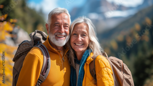 Two smiling elderly people in outdoor attire posing for a photo with nature in the background. Ai generative