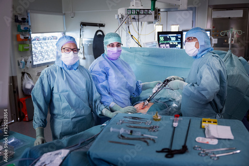 Surgeons doing laparoscopic surgery of patient in operation theater at hospital photo