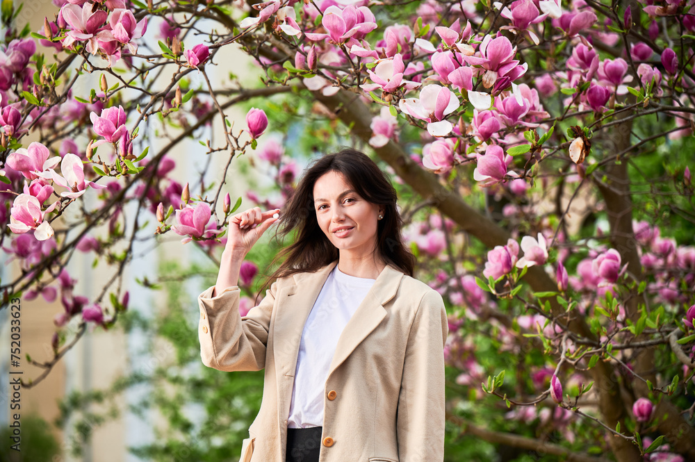 Woman allergic suffering from seasonal allergy at spring. Young happy woman showing allergy drugs, posing in blossoming garden at springtime. Antihistamine medication concept Woman allergic suffering from seasonal allergy at spring. Young happy woman showing allergy drugs, posing in blossoming garden at springtime. Antihistamine medication concept