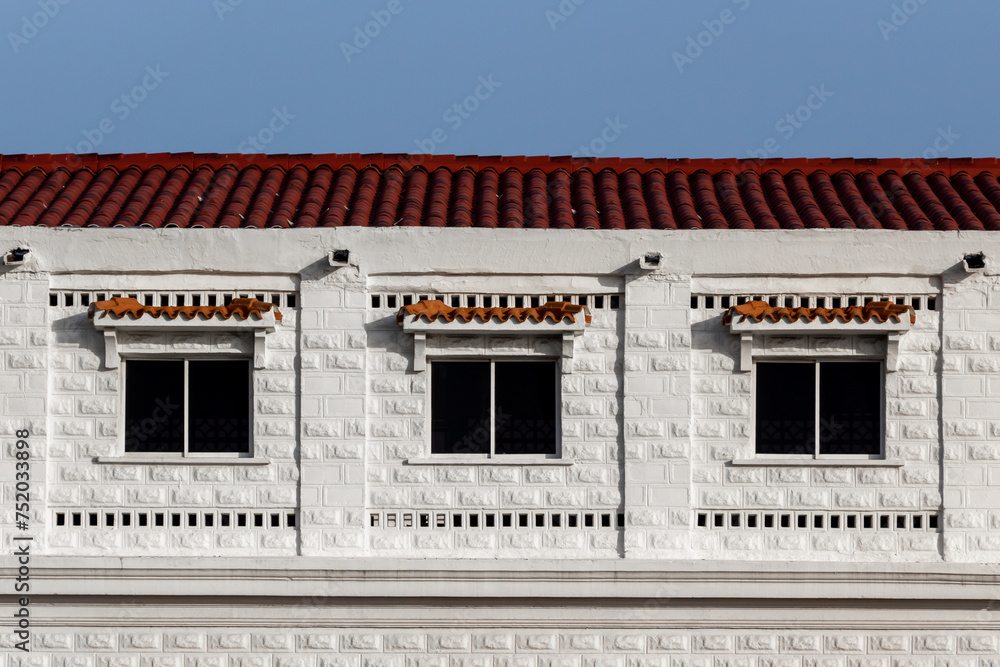 3 symmetrical windows of white historical building 3 symmetrical windows of white historical building