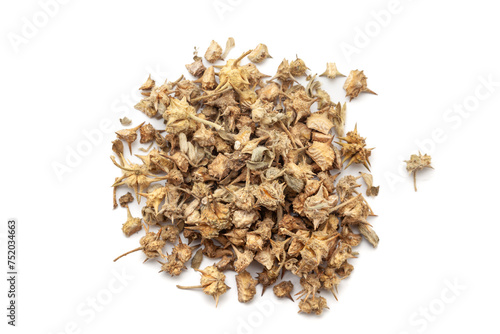 A pile of Dry Organic gokhuru (Tribulus terrestris) fruits, isolated on a white background. Top view