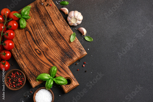 Food background with space for text. Wooden board with vegetables and spices