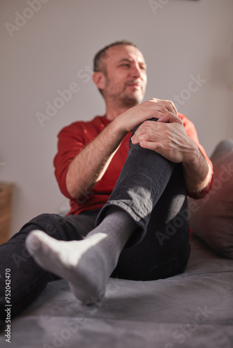 Man with knee pain at home.