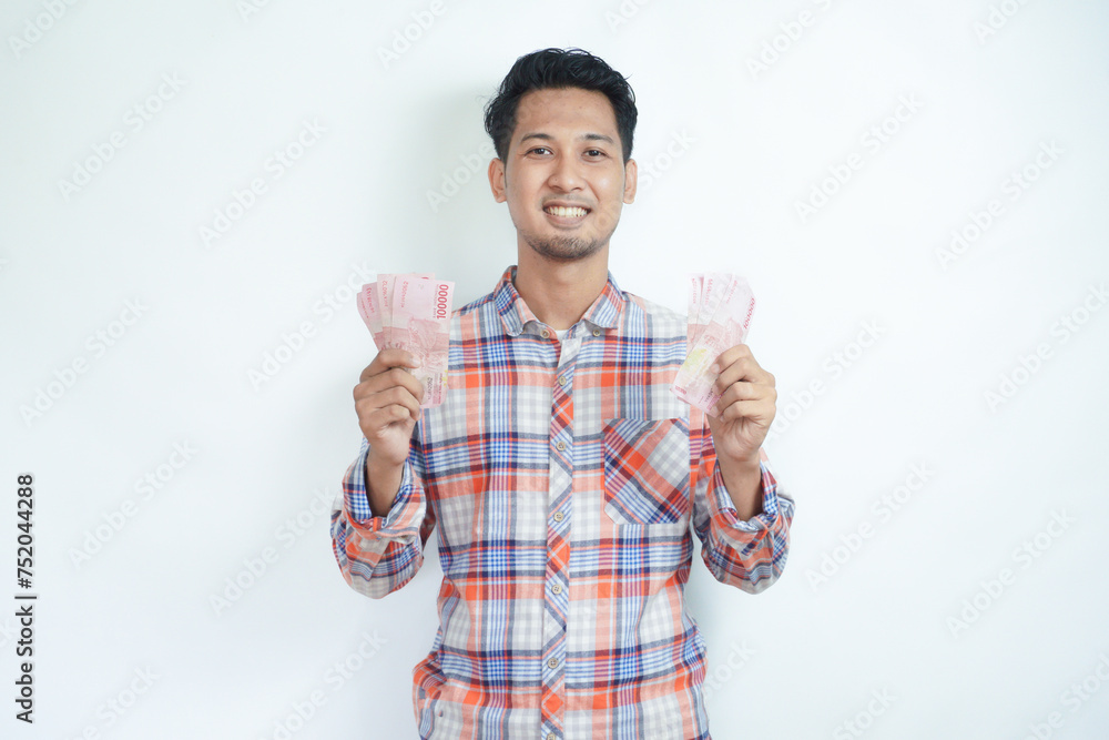 Fototapeta premium Adult Asian man smiling happy at camera while holding money
