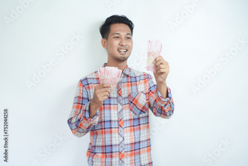 Adult Asian man laughing happy while holding money photo