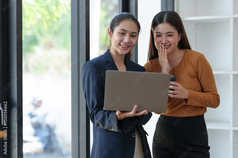 Two Asian business women Discussing new startup projects Financial reports, project presentations, analytical concepts, planning and financial statistics and investment markets at the office. Two Asian business women Discussing new startup projects Financial reports, project presentations, analytical concepts, planning and financial statistics and investment markets at the office.