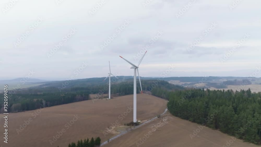 Drone view of wind farms in natural landscape. Cheap, sustainable and renewable energy. High-altitude wind-powered turbines solve the energy crisis Drone view of wind farms in natural landscape. Cheap, sustainable and renewable energy. High-altitude wind-powered turbines solve the energy crisis