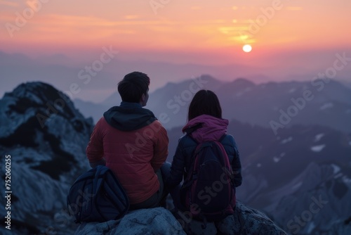 A couple enjoying the view from a mountain top. Perfect for travel blogs or inspirational posters