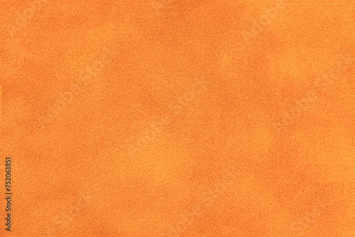 Foto Bright orange matte background of suede fabric, closeup