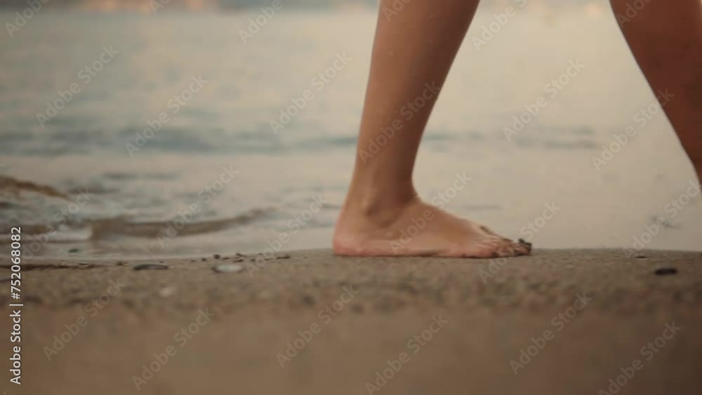 Legs of girl stepping and relaxing on sandy coast Legs of girl stepping and relaxing on sandy coast