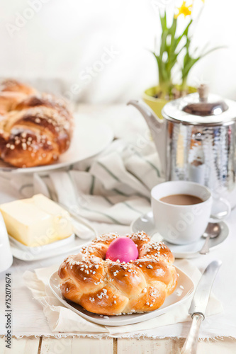 Braided Easter bread with pink egg  daffodil  coffee and butter