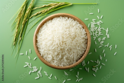 Bowl with rice grains and spikelets on color background. Top view