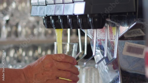 Dispensing a sparkling beverage into a cup from a modern soda fountain in 4k slow motion 120fps