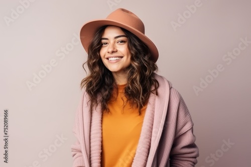 Portrait of a beautiful smiling young woman in hat and coat.