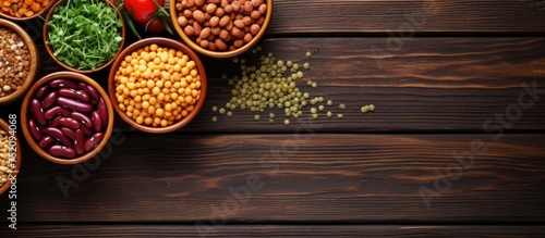 Assorted Beans and Legumes in Rustic Bowls on Wooden Background with Copy Space
