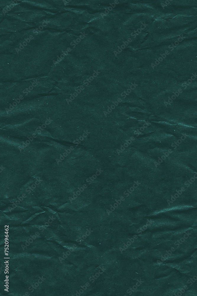 A close-up of a wrinkled, dark green textured paper A close-up of a wrinkled, dark green textured paper