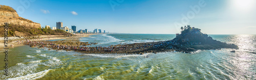 Aerial view of Hon Ba island in Vung Tau city, Vietnam. On full moon day of lunar calendar, when tide is low, people can walk across island to visit temple on mountain. Spiritual travel concept. photo